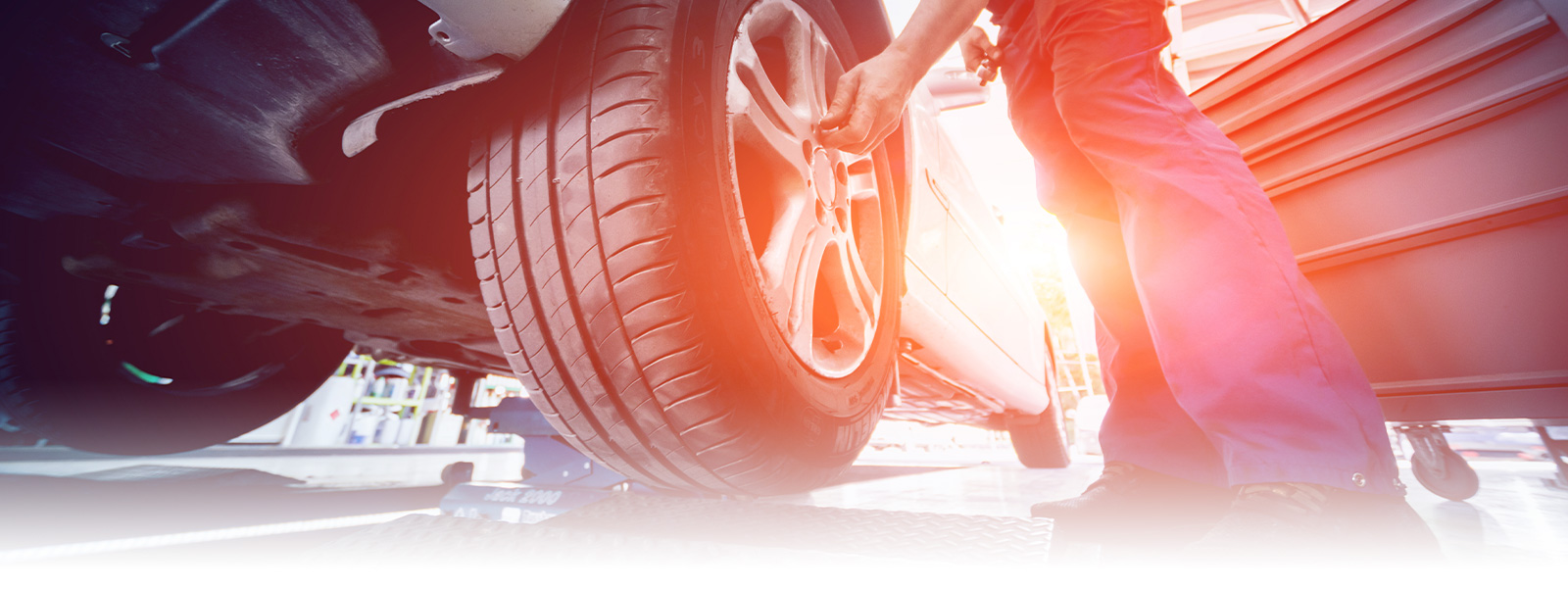 Photo of Mechanic fixing the tire of the car